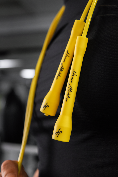 Jump rope handles held up against the chest to check rope length